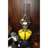 A VINTAGE YELLOW GLASS OIL LAMP WITH CAST BASE