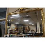 A LARGE GILT FRAMED MIRROR