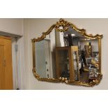 A LARGE GILT FRAMED MIRROR