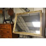 A LARGE GILT FRAMED MIRROR