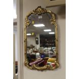 A DECORATIVE GILT FRAMED MIRROR