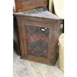 A 19TH CENTURY OAK GLAZED HANGING CORNER CABINET