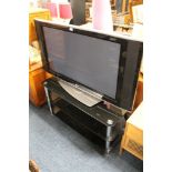 A LARGE LG FLATSCREEN TV AND GLASS STAND (NO REMOTE / CABLE)