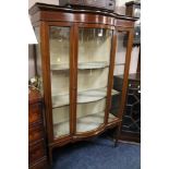 AN EDWARDIAN BOW FRONTED DISPLAY CABINET