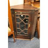 A 19TH CENTURY OAK GLAZED SINGLE DOOR HANGING CORNER CABINET