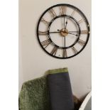 A MODERN OPEN WALLCLOCK AND A GREEN RUG (2)