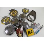 A SET OF FOUR CHROMED KNOCK-ON WHEEL NUTS, together with various AA and other motoring badges