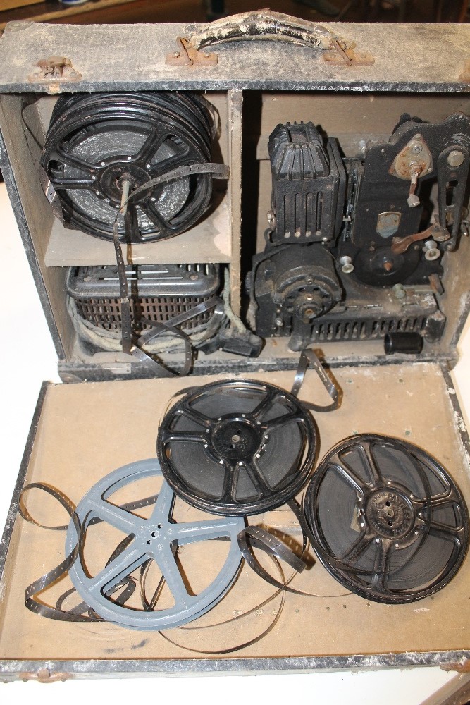 A VINTAGE PATHESCOPE 9.5 PROJECTOR, in case, along with a quantity of reels of film