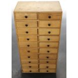 A SMALL WOODEN CABINET FITTED WITH TWENTY DRAWERS. Height 59cm
