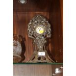 AN ART NOUVEAU CAST METAL MANTEL CLOCK WITH CHERUBIC FINIALS