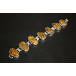 A LADIES SILVER AND AMBER BRACELET