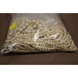 A BAG OF FAUX PEARL NECKLACES