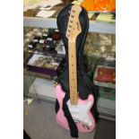 A PINK ELECTRIC GUITAR IN CARRY BAG