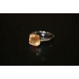 A BOXED 9CT WHITE GOLD LADIES DRESS RING SET WITH AN ORANGE STONE