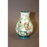 A MOORCROFT SQUAT VASE WITH HOLLY DECORATION