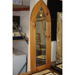 A LEADED ARCHED OAK FRAMED MIRROR