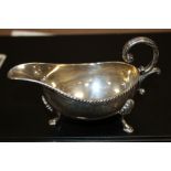 A HALLMARKED SILVER SAUCE BOAT