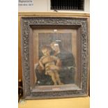 A LARGE HEAVILY CARVED OAK PICTURE FRAME CONTAINING A BIBLICAL PRINT