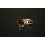 A HALLMARKED 9CT GOLD RING SET WITH A LARGE CITRINE STONE