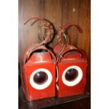 A PAIR OF RED PAINTED ROAD LAMPS