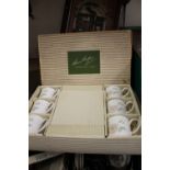 A BOXED SUSIE COOPER SET OF SIX WILD ROSE CUPS AND SAUCERS