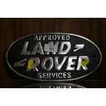 A METAL LAND ROVER SIGN