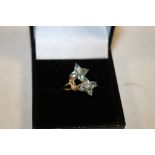 A 9CT GOLD FLORAL BLUE TOPAZ DRESS RING