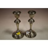 A PAIR OF HALLMARKED SILVER CANDLESTICKS - ONE A/F