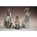 THREE NAO FIGURES OF CHILDREN WITH DOGS