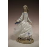 A LLADRO FIGURE OF A LADY LOSING HER SLIPPER