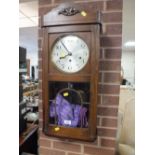 AN OAK CASED WALLCLOCK