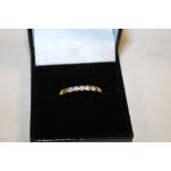 A 9CT GOLD FIVE STONE DIAMOND RING