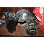 A BLACK WWII MILITARY HELMET TOGETHER WITH A GAS MASK ETC