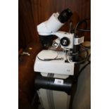 A CASED APEX DISCOVERY MICROSCOPE