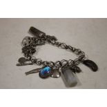 AN ANTIQUE SILVER CHARM BRACELET