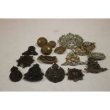 A BAG OF STAFFORDSHIRE YEOMANRY CAP BADGES PLUS SIX PLASTIC ECONOMY CAP BADGES