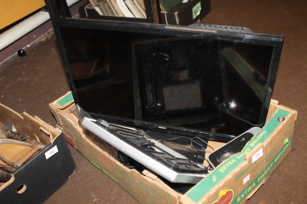 A SEIKI FLATSCREEN TV TOGETHER WITH TWO LOGITECH SPEAKERS