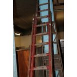 A LARGE SET OF RED WOODEN LADDERS TOGETHER WITH TWO SETS OF WOODEN STEPS A/F