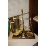 A SET OF BRASS SCALES AND WEIGHTS ON WOODEN PLINTH