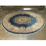 A BLUE OVAL RUG