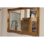 A LARGE GILT FRAMED MIRROR