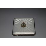 A HALLMARKED SILVER AND GUILLOCHE ENAMEL COMPACT FOR THE ROYAL ARMY MEDICAL CORPS BY DEAKIN & FRANC