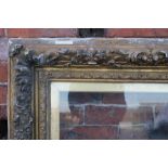 AN ANTIQUE ORNATE GILTWOOD PICTURE FRAME, glazed, rebate 70 x 90 cm