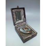 A CASED HALLMARKED SILVER BANDED GROOMING SET, comprising brush, comb and mirror, the brush having