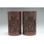 A PAIR OF CHINESE BAMBOO BRUSH POTS, carved with scholars amongst the bamboo, H 17 cm (2)