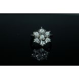 A 1 CARAT DIAMOND CLUSTER RING, having brilliant cut diamonds illusion set in hallmarked 9 carat go