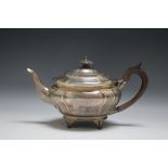 A HALLMARKED SILVER TEAPOT BY GOLDSMITHS AND SILVERSMITHS CO LTD - LONDON 1924, sitting on four spl