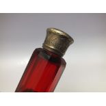 A SAMSON MORDAN DOUBLE ENDED SCENT BOTTLE WITH GILT METAL MOUNTS, the body having faceted cranberry