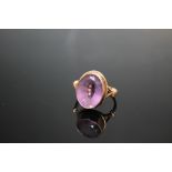 A LARGE AMETHYST DRESS RING, on yellow metal band stamped 9ct, the oval amethyst measuring approxim