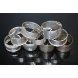 A COLLECTION OF NINE HALLMARKED SILVER NAPKIN RINGS, various dates, makers and styles, approx comb